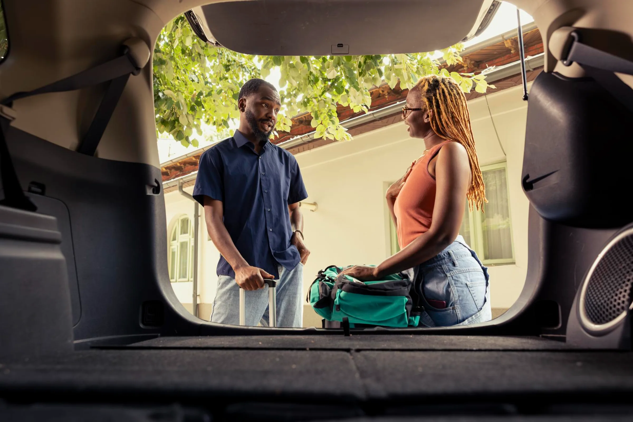Couple loading luggage into a car